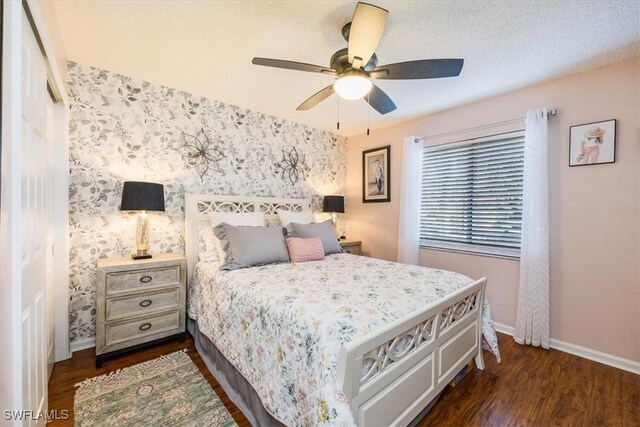 4572 Andover Way Unit C102, Naples, FL 34112 - bedroom featuring baseboards, wallpapered walls, ceiling fan, and dark wood-style floors