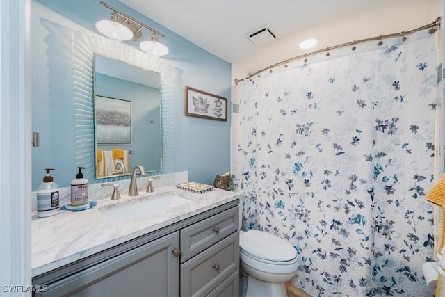 4572 Andover Way Unit C102, Naples, FL 34112 - full bathroom featuring visible vents, toilet, vanity, and a shower with curtain