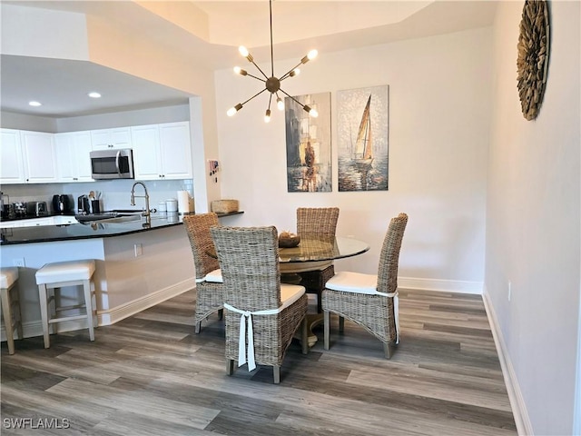 dining area with a notable chandelier and dark hardwood / wood-style floors