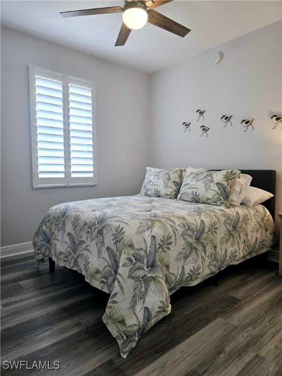 bedroom featuring dark hardwood / wood-style flooring and ceiling fan