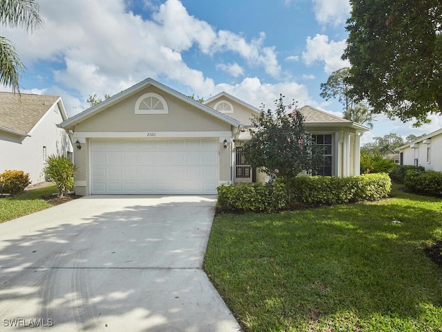 view of front of property featuring a garage and a front lawn