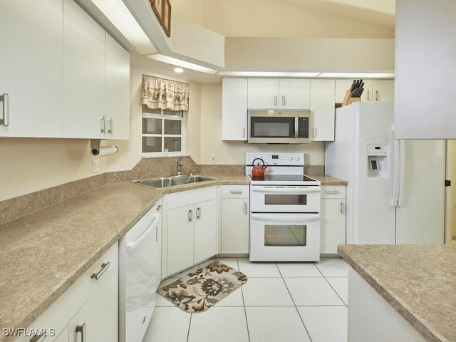 kitchen with lofted ceiling, sink, white cabinets, light tile patterned floors, and white appliances