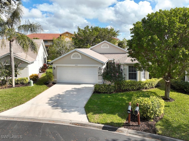 view of front of house with a garage and a front yard