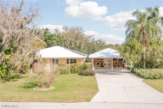 view of front of house with a carport and a front lawn