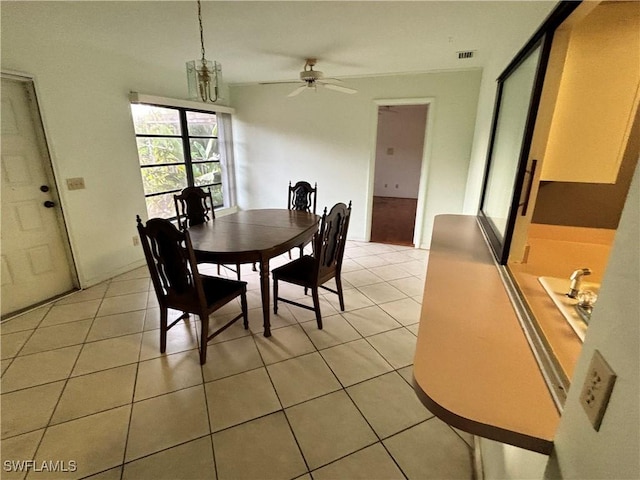 dining area featuring ceiling fan and light tile patterned flooring