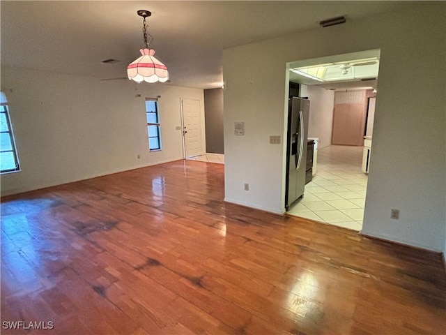 spare room with light hardwood / wood-style flooring