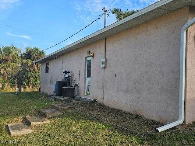 view of property exterior with a lawn