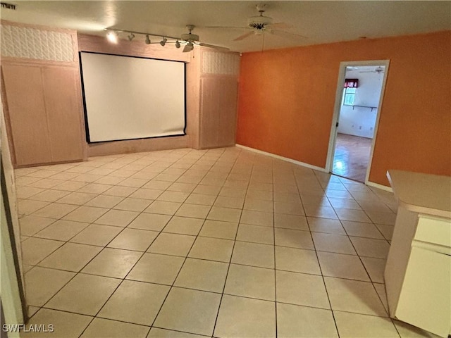 home theater featuring light tile patterned floors, track lighting, and ceiling fan