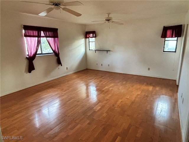 empty room featuring wood-type flooring and ceiling fan