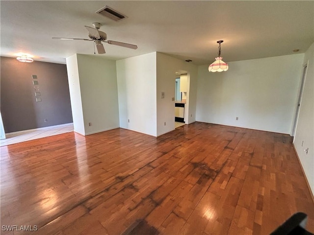 spare room featuring hardwood / wood-style flooring and ceiling fan