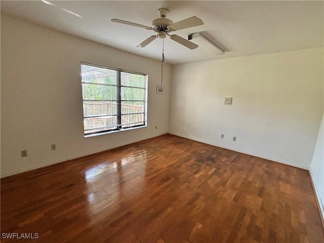 spare room with dark hardwood / wood-style floors and ceiling fan