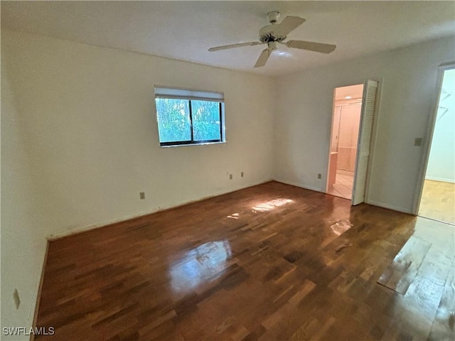 unfurnished bedroom with ceiling fan, dark hardwood / wood-style flooring, and ensuite bath