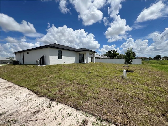 view of property exterior featuring a lawn