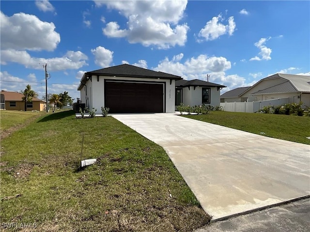 view of front of house featuring a garage and a front lawn