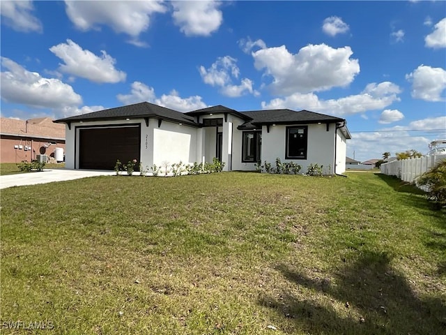 view of front of house featuring a garage and a front lawn