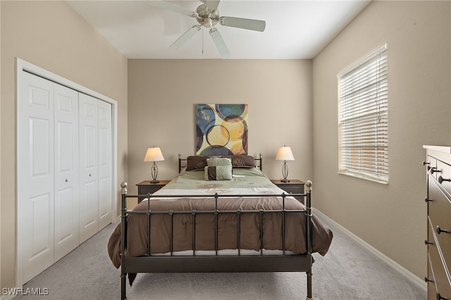 carpeted bedroom with a closet and ceiling fan