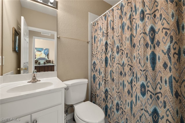 bathroom featuring a shower with curtain, vanity, and toilet