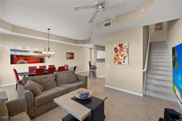 living room featuring light tile patterned floors and ceiling fan with notable chandelier