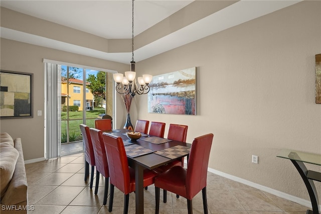 tiled dining room with an inviting chandelier