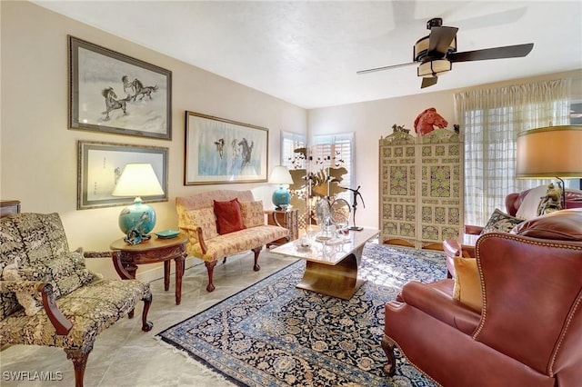 sitting room with a ceiling fan