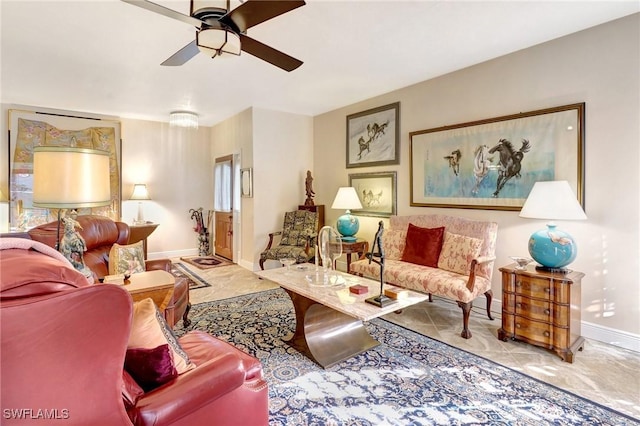 living area featuring light tile patterned floors, baseboards, and a ceiling fan