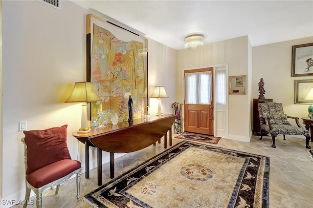 entryway with marble finish floor, visible vents, and baseboards