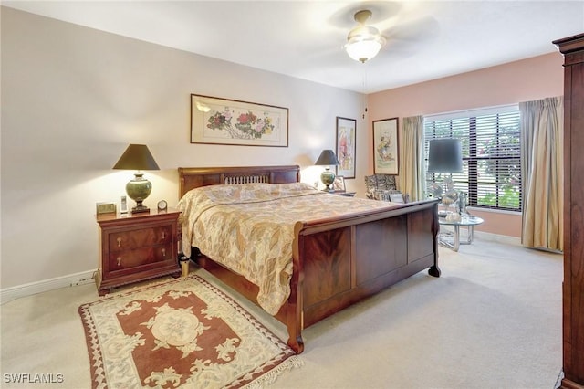 bedroom featuring light colored carpet and baseboards