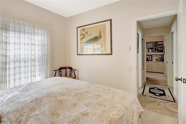 bedroom featuring multiple windows and light colored carpet