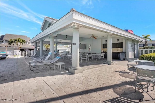 view of patio featuring outdoor dining space, ceiling fan, a gazebo, and fence