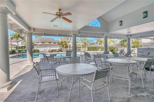 view of patio with a ceiling fan and a community pool