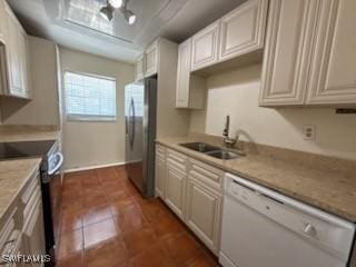 kitchen featuring range with electric stovetop, stainless steel refrigerator, dishwasher, white cabinetry, and sink