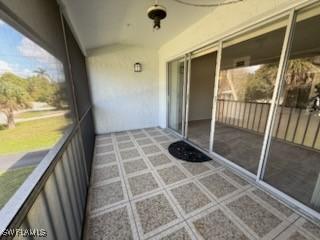 unfurnished sunroom featuring lofted ceiling