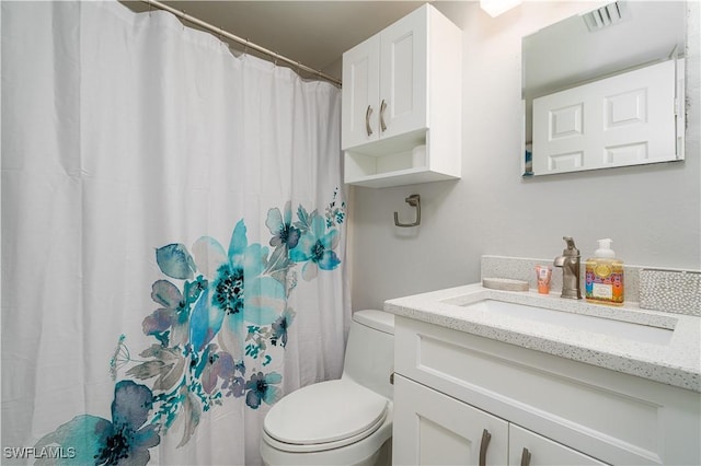 bathroom with vanity and toilet