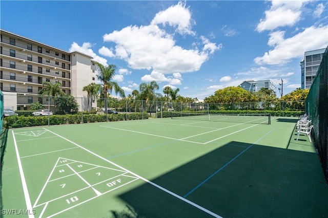 view of home's community with tennis court