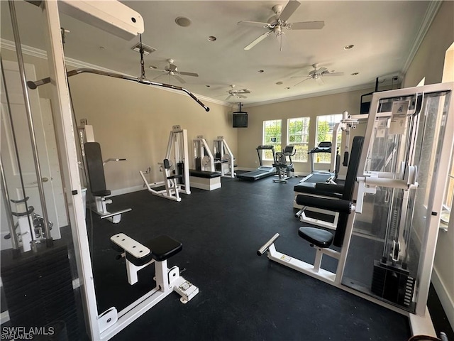 workout area featuring a ceiling fan, crown molding, baseboards, and visible vents