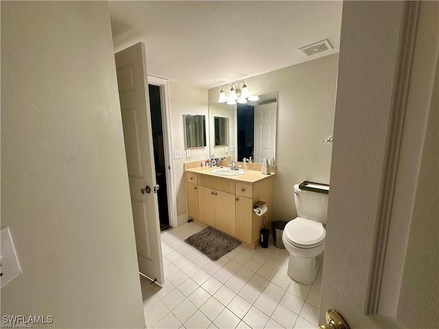 bathroom with vanity, tile patterned flooring, a chandelier, and toilet