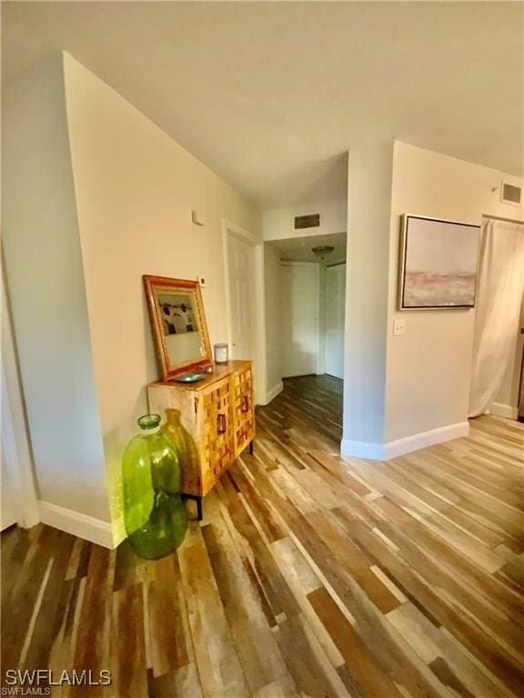 hallway with wood-type flooring