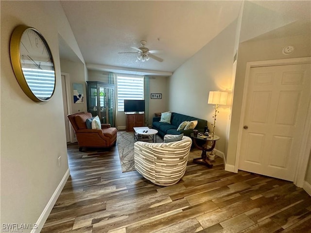 living room featuring ceiling fan, vaulted ceiling, and dark hardwood / wood-style flooring