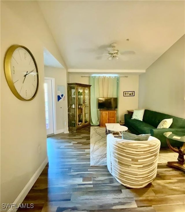 living room featuring hardwood / wood-style floors and ceiling fan