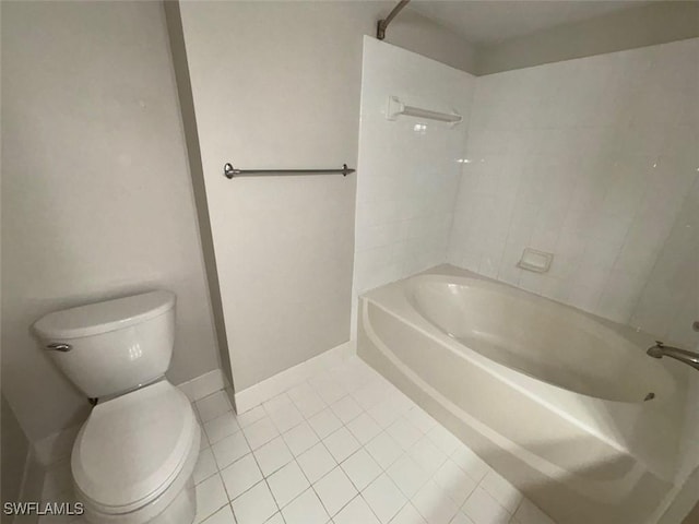 bathroom with baseboards, toilet, tile patterned flooring, and bathing tub / shower combination