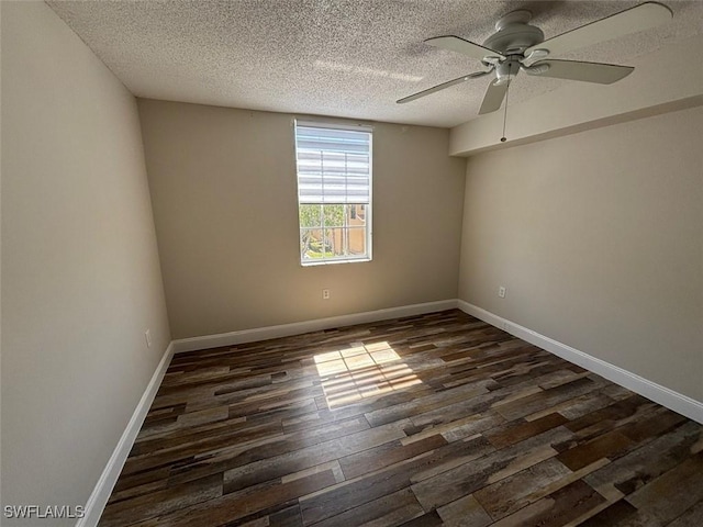 spare room with baseboards, a ceiling fan, a textured ceiling, and dark wood-style flooring