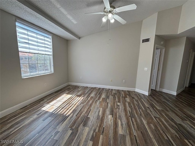 unfurnished room with dark wood-style flooring, a textured ceiling, baseboards, and visible vents