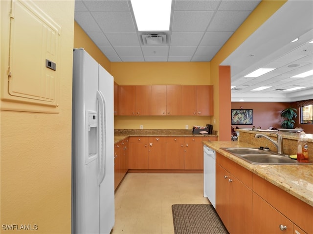 kitchen with sink, a drop ceiling, electric panel, and white appliances