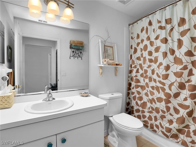 bathroom featuring vanity, tile patterned floors, and toilet