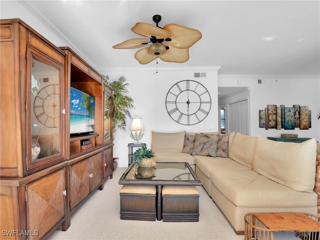 carpeted living room with ceiling fan and ornamental molding