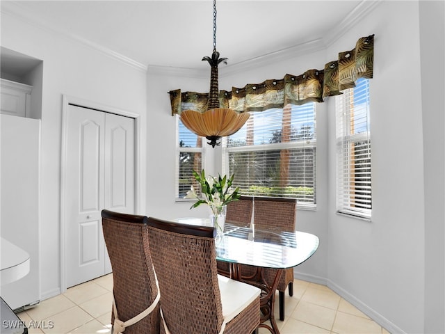 tiled dining space featuring ornamental molding