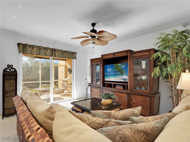 carpeted living room with crown molding and ceiling fan