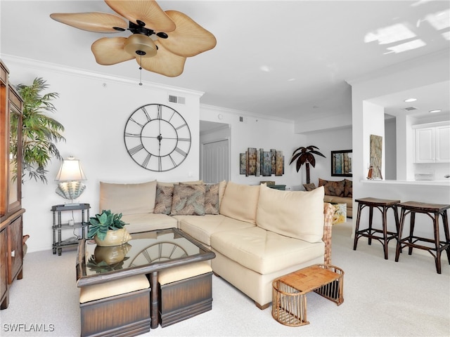 carpeted living room featuring crown molding and ceiling fan