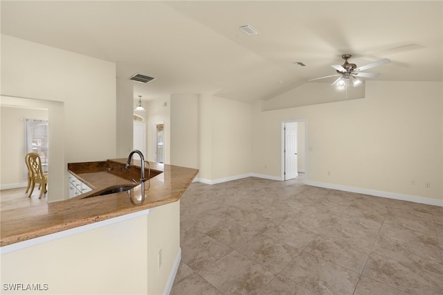 kitchen featuring hanging light fixtures, lofted ceiling, sink, and ceiling fan