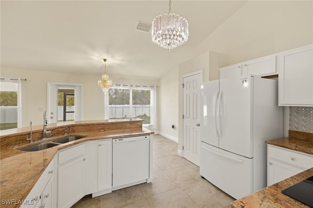 kitchen with sink, white appliances, an inviting chandelier, hanging light fixtures, and white cabinetry